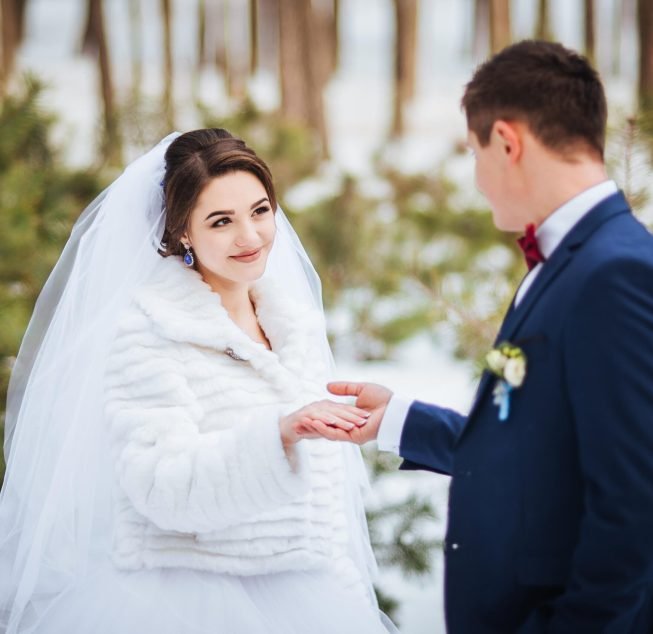 Happy bride and groom in winter day on their wedding, photo session.